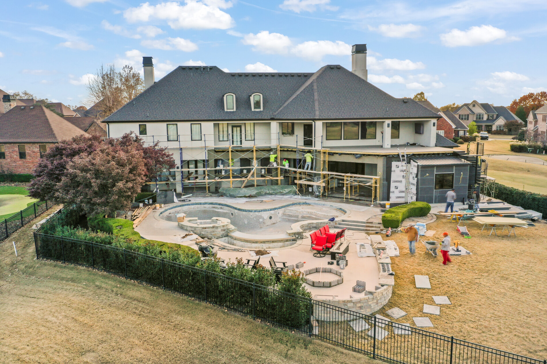 Drone view of the Shadow Valley backyard remodel showing continued pool construction, exterior improvements, and surrounding landscape work.